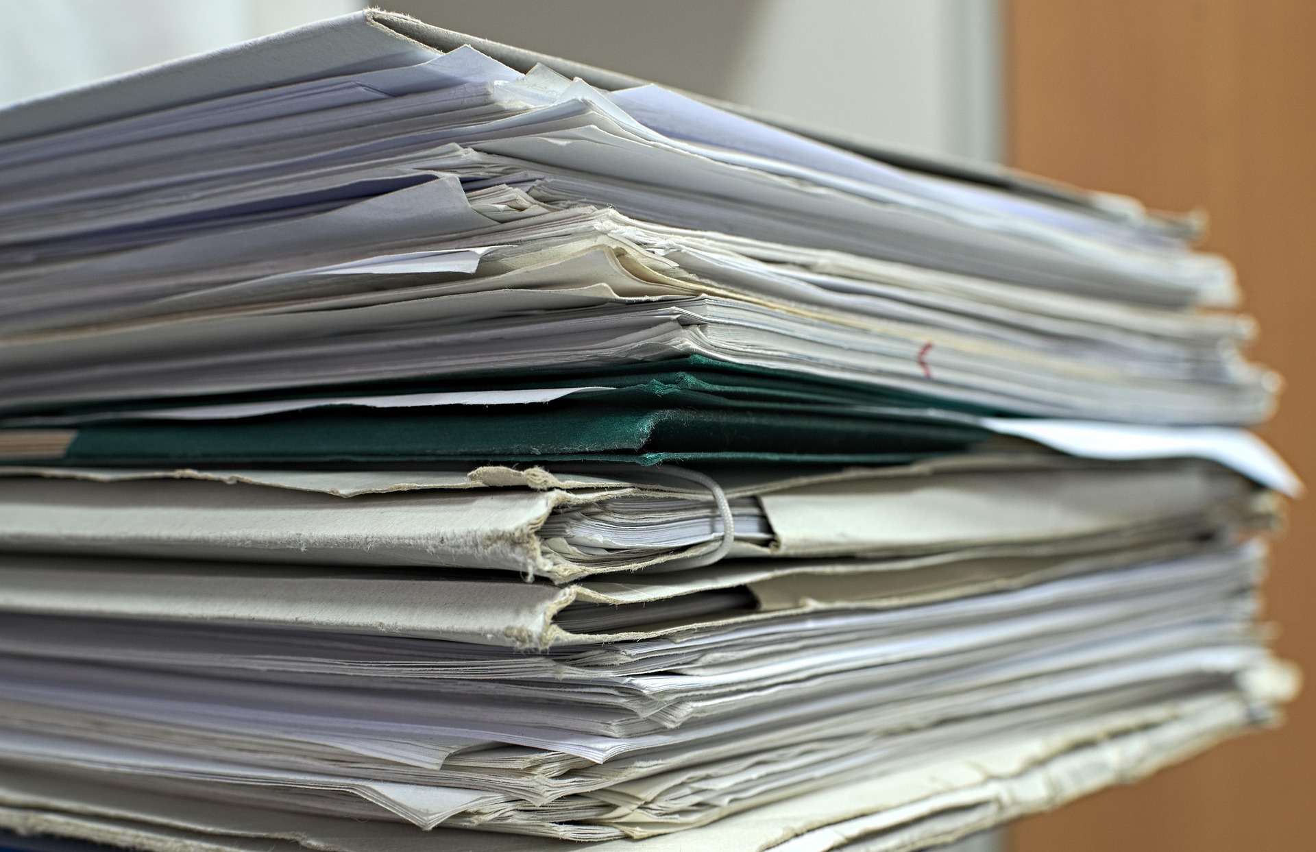 Stacked folders and paperwork for shipment documentation