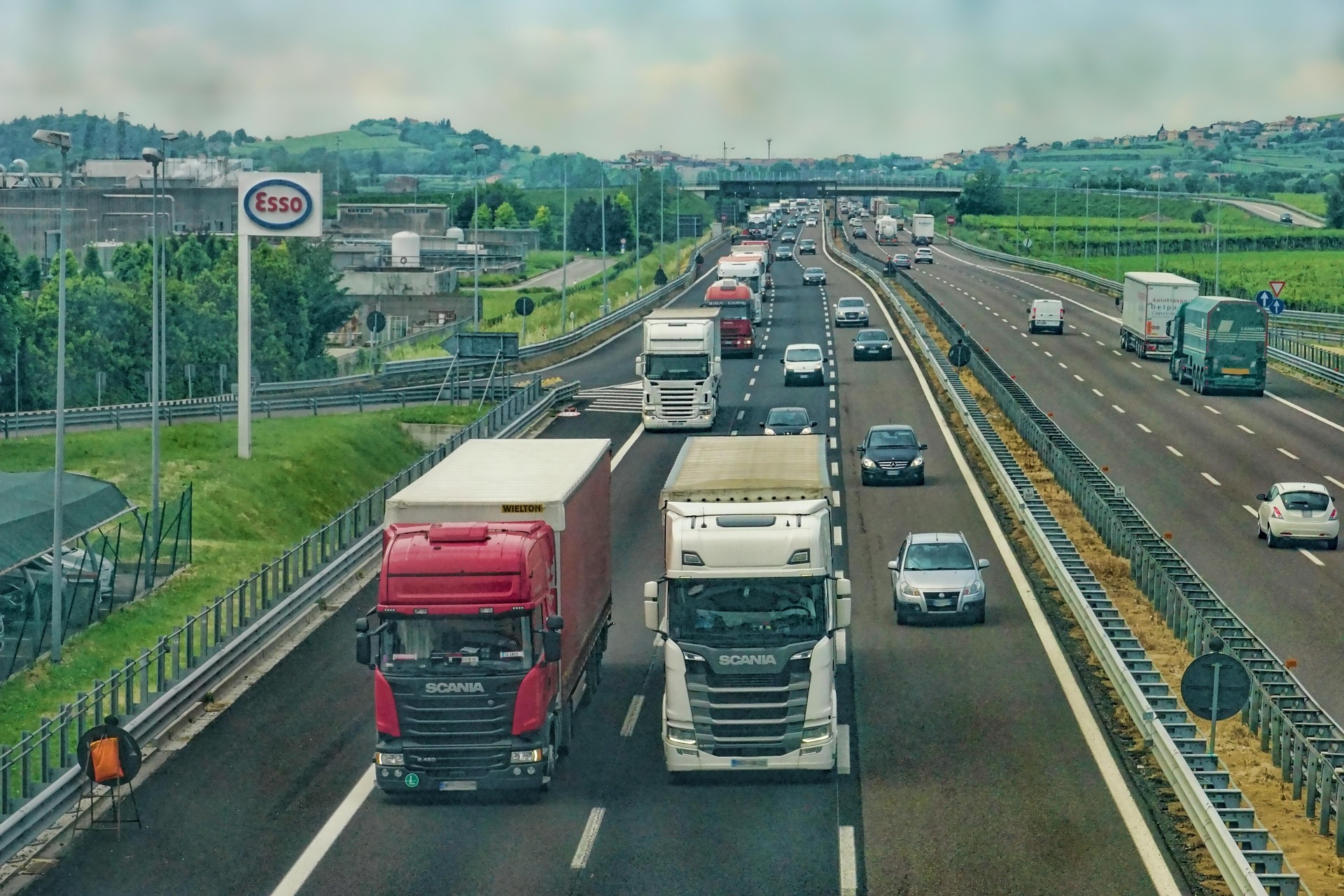 Freight trucks moving along a highway
